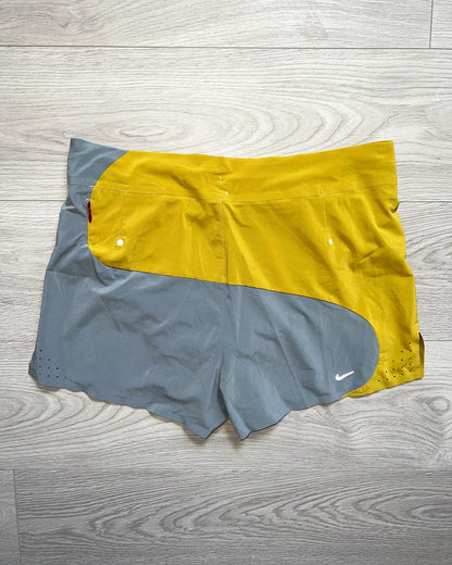 Nike Undercover Gyakusous Spring 2014 Nylon Technical Shorts - An innovative approach to sportswear and running gear by Jun Takahashi, the shorts feature an amazing curved split design with contrasting yellow and grey tones. 