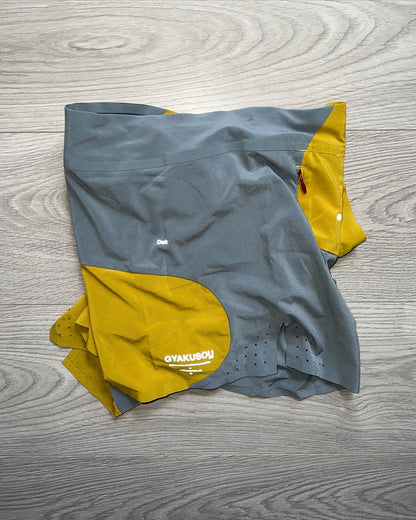 Nike Undercover Gyakusous Spring 2014 Nylon Technical Shorts - An innovative approach to sportswear and running gear by Jun Takahashi, the shorts feature an amazing curved split design with contrasting yellow and grey tones. 