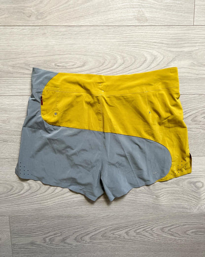 Nike Undercover Gyakusous Spring 2014 Nylon Technical Shorts - An innovative approach to sportswear and running gear by Jun Takahashi, the shorts feature an amazing curved split design with contrasting yellow and grey tones. 